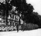 In September 1945, 20,000 British troops of the 20th Indian Division occupied Saigon under the command of General Sir Douglas David Gracey. During the Potsdam Conference in July 1945, the Allies had agreed on Britain taking control of Vietnam south of the 16th parallel (then part of French Indochina) from the Japanese occupiers. Meanwhile, Ho Chi Minh proclaimed Vietnamese independence from French rule and major pro-independence and anti-French demonstrations were held in Saigon. Ho Chi Minh was the leader of the communist Viet Minh.<br/><br/>

The French, anxious to retain their colony, persuaded Gracey's Commander in Chief, Lord Mountbatten, to authorise Gracey to declare martial law. Fearing a communist takeover of Vietnam, Gracey decided to rearm French citizens who had remained in Saigon. He allowed them to seize control of public buildings from the Viet Minh. In October 1945, as fighting spread throughout the city, Gracey issued guns to the Japanese troops who had surrendered. He used them to help maintain colonial rule.<br/><br/>

According to some socialist and communist commentaries, this controversial decision furthered Ho Ch Minh's cause of liberating Vietnam from foreigners' rule and precipitated the First Indochina War. French General Leclerc arrived in Saigon in October 1945 to assume authority but it was not until well into the first half of 1946 that enough French troops had arrived to allow General Gracey to return with his troops to India where the 20th Indian Division was disbanded.
